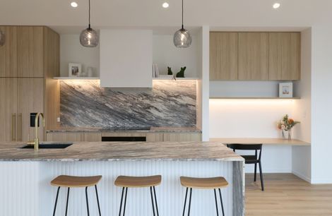 Curved Timber Island with Leathered Granite Elegance