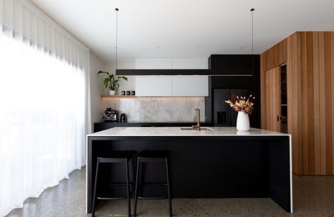 A Contemporary Black Kitchen Features Dekton Bergen