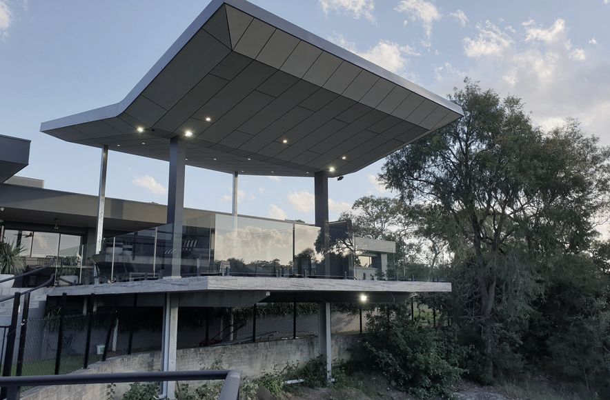 Annangrove Patio: Butterfly Roof Framing Mountainous Views