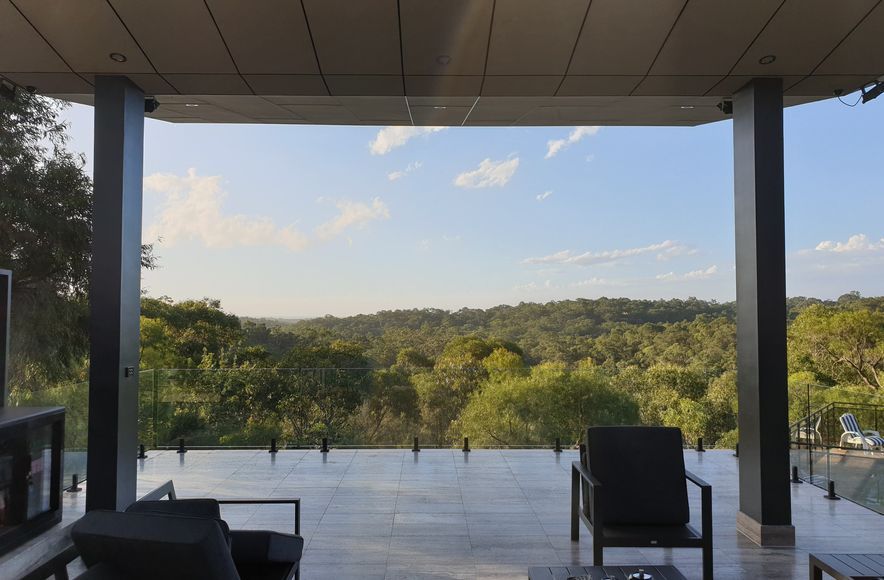 Annangrove Patio: Butterfly Roof Framing Mountainous Views